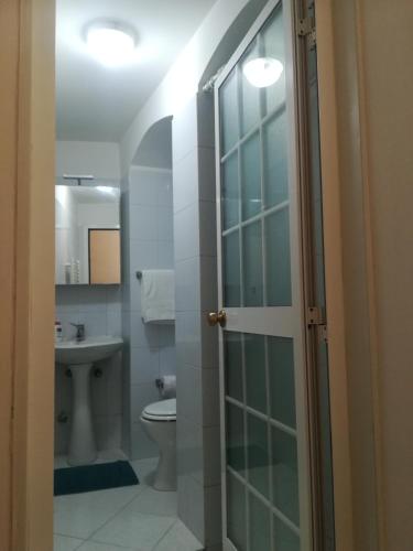 a bathroom with a toilet and a sink at Tra le cummerse in Locorotondo