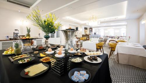 a buffet of food on a table in a restaurant at Heritage hotel Santa Lucia in Split