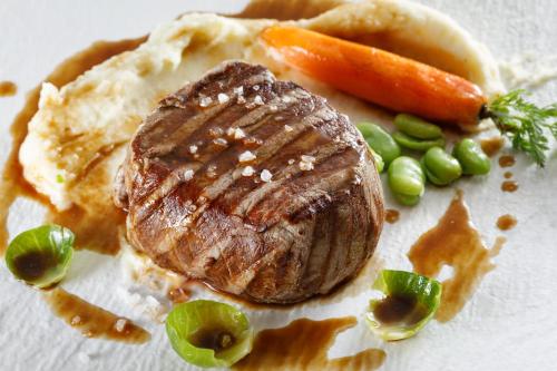 a piece of steak and vegetables on a plate at Heritage hotel Santa Lucia in Split