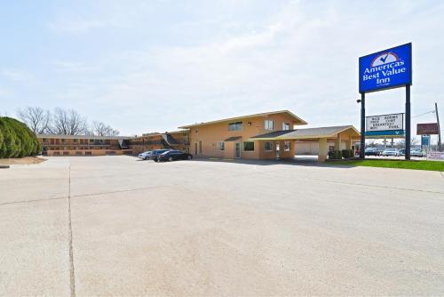 a parking lot in front of a building with a sign at Americas Best Value Inn Ponca City in Ponca City