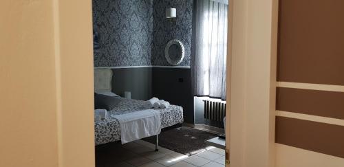 a small room with a bed and a window at B&B Villa Rivabella in Bologna