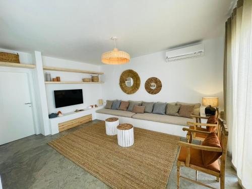 a living room with a couch and a tv at Villa Sal - Alvor in Alvor