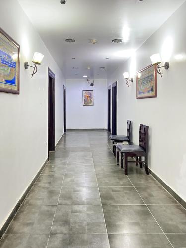 a waiting room with benches and paintings on the walls at Best View Pyramids Hotel in Cairo