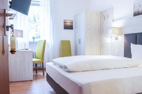Ένα ή περισσότερα κρεβάτια σε δωμάτιο στο Hotel Ehranger Hof