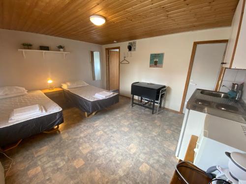 a room with two beds and a piano in it at Economy Apartments Peura in Rovaniemi
