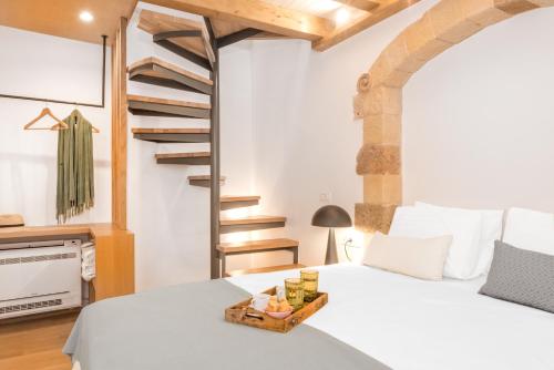a bedroom with a white bed and a staircase at Casa Livieres in Chania Town