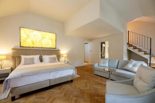 a large bedroom with a bed and a couch at Heritage hotel Santa Lucia in Split