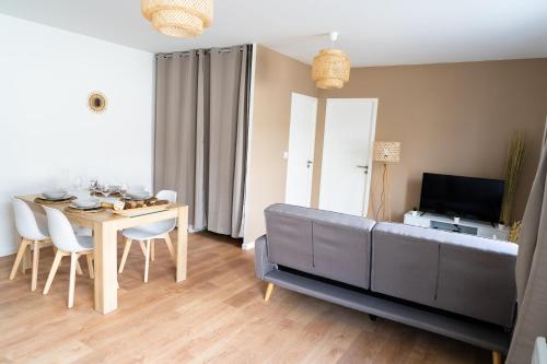 sala de estar con sofá y mesa en Spacieux appartement proche centre-ville, en Saumur
