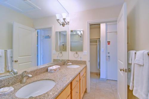 a bathroom with two sinks and a large mirror at Napili Sunset Beach Front Resort in Lahaina