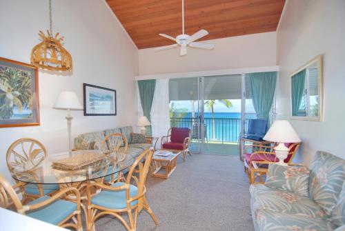 a living room with a table and chairs at Napili Sunset Beach Front Resort in Lahaina