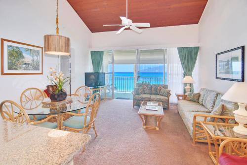 a living room with a couch and a table at Napili Sunset Beach Front Resort in Lahaina