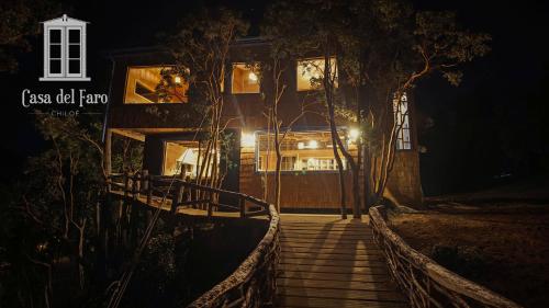 a house at night with stairs leading up to it at Casa del Faro Chiloé in Castro