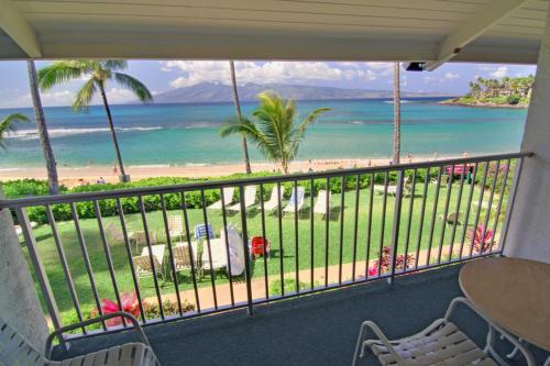 a balcony with a view of the beach and ocean at Napili Sunset Beach Front Resort in Lahaina