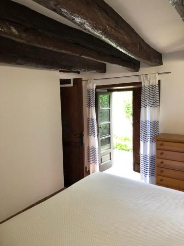 a bedroom with a bed and an open door at Casas Rurales Hermigua in Hermigua