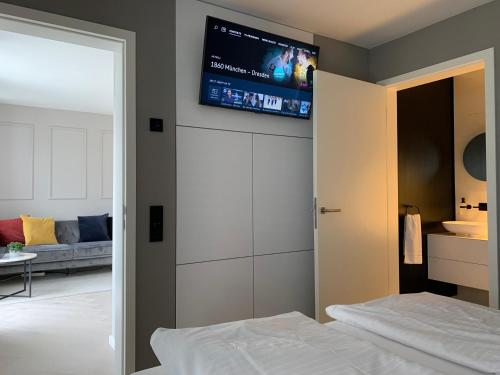a bedroom with a bed and a tv on the wall at Ferienhaus Stadtblick in Bad Marienberg