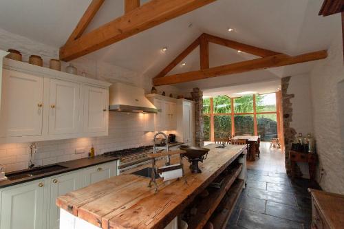 a kitchen with a wooden counter top in a room at ANRÁN at Tidwell Farm in Staverton