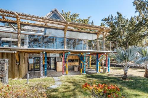 a large wooden building with a balcony on it at Lagoon Attitude (Adults Only) in Cap Malheureux