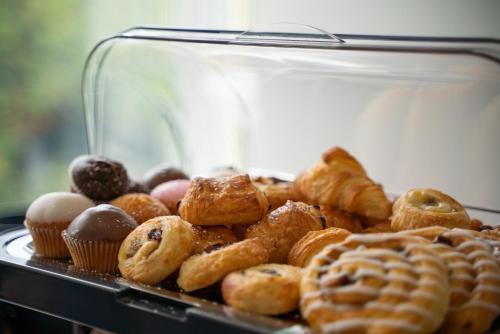 a tray of different types of donuts and pastries at The Lodge at Woodenbridge in Arklow