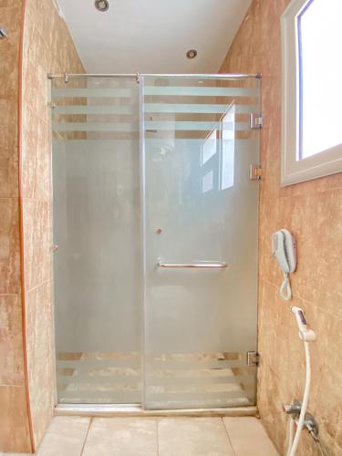 a shower with a glass door in a bathroom at Best View Pyramids Hotel in Cairo