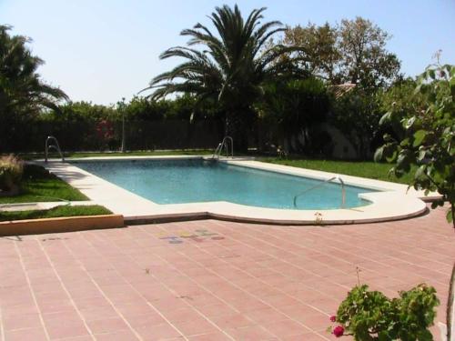 una piscina en un patio con un patio de ladrillo en Finca La Tacita - Rosal, en Conil de la Frontera