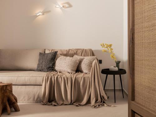a couch with pillows on it in a living room at Boletsos Beach in Argasi