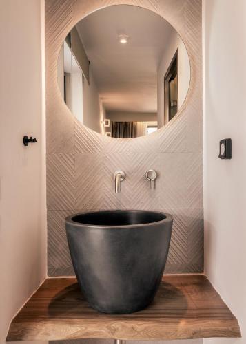 a bathroom with a large tub in front of a mirror at Boletsos Beach in Argasi
