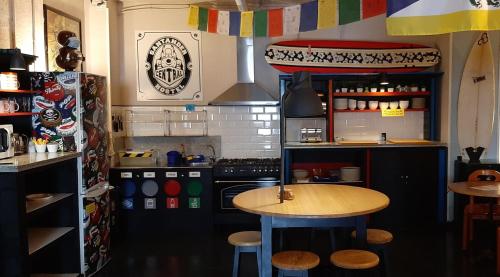 a kitchen with a table and a stove and a counter at Santander Central Hostel in Santander