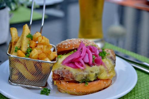 a plate of food with a sandwich and french fries at Cresta Grande Cape Town in Cape Town