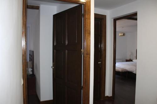 an open door to a bedroom with a bed at Apartamentos rurales 'Los Soportales' in Tendilla