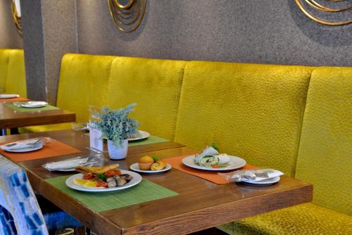 a table with plates of food on top at Cresta Grande Cape Town in Cape Town