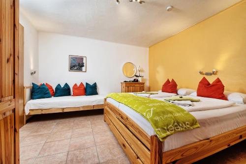 a bedroom with two beds and a mirror at Theresienhof in Petschnitzen