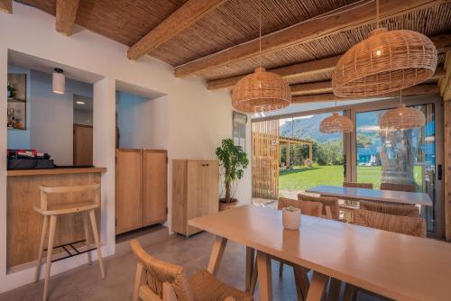 a kitchen and dining room with a table and chairs at Paradise Elegant Apartments - Perfect escape on the beach in Alykes