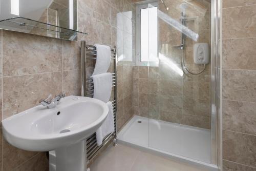 a bathroom with a sink and a shower at Beechwood in Bowness-on-Windermere