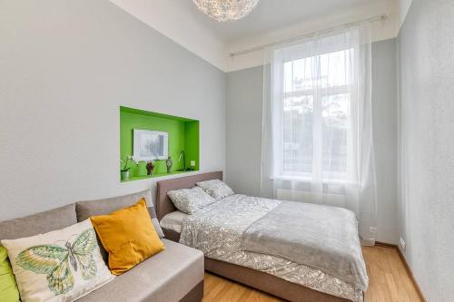 a bedroom with a bed and a couch and a window at 6 can stay! Parking Free! Old Town 6min. Shop 3min in Riga