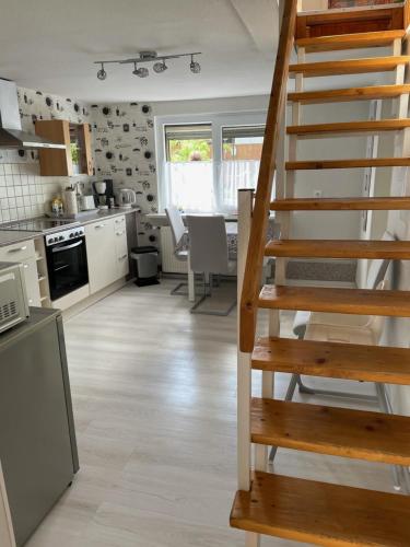 a kitchen with a spiral staircase in a kitchen at gemütliches, freistehendes Ferienhaus in Koblenz