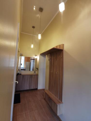 a bathroom with a wooden cabinet in a room at Cietokšņa 34 in Daugavpils