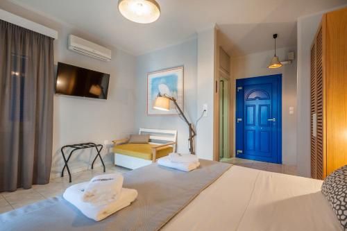 a room with a bed with a blue door at ARMONIA 1 & 2 in Myrina