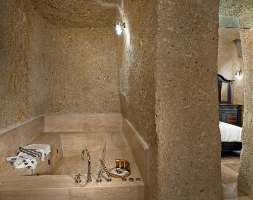a bathroom with a bath tub with a sink at Seraphim Cave Suites & SPA in Urgup