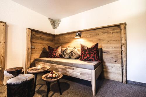 a room with a bed with pillows and two tables at Haus Stüttler/Duchscherer in Schruns