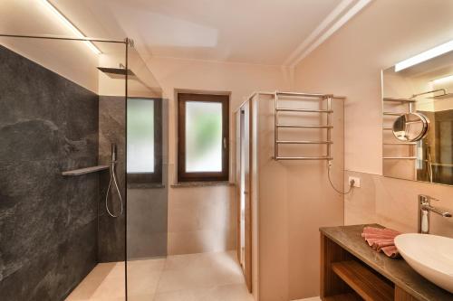 a bathroom with a shower and a sink at Residence Boutique Sonne in Schenna