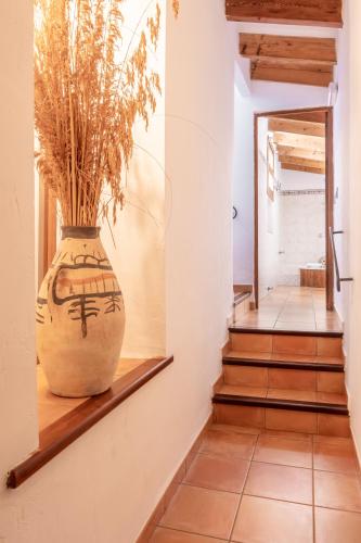 a large vase sitting on a shelf in a hallway at Son Borguny in Banyalbufar