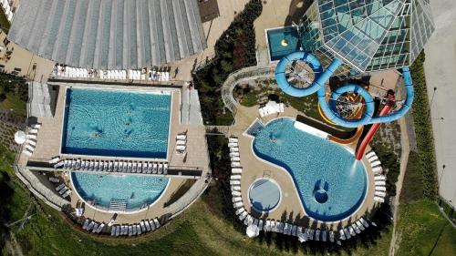 an overhead view of two swimming pools next to a building at Hotel BUKOVINA in Bukowina Tatrzańska