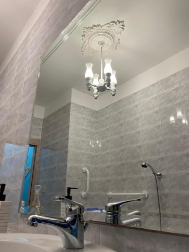 a bathroom with a mirror and a sink at Villa Del Mare in Campomarino