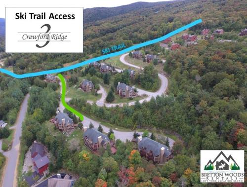an aerial view of a house with a road in the woods at C3 Crawford Ridge Townhome with Mt Washington views - just a short walk from ski lodge and slopes in Carroll
