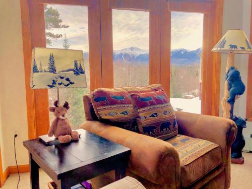 a living room with a teddy bear sitting on a table at C6 Beautiful views from this Crawford Ridge Townhome a short walk from the slopes in Carroll