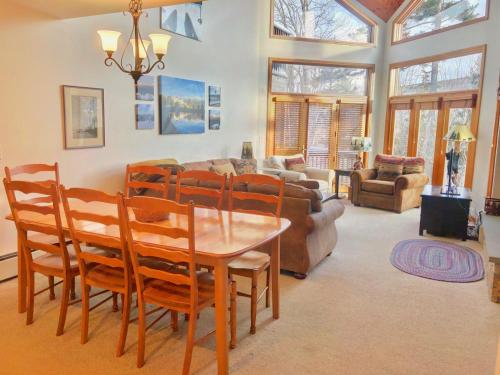 a living room with a wooden table and chairs at C6 Beautiful views from this Crawford Ridge Townhome a short walk from the slopes in Carroll