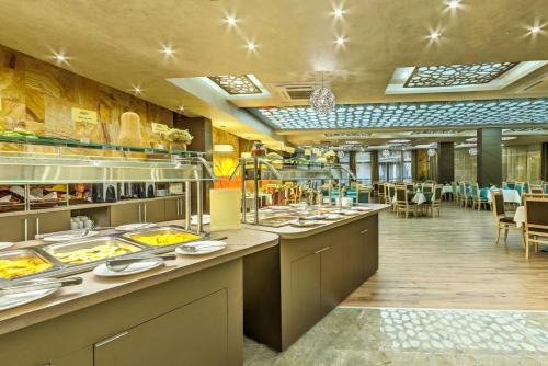 a restaurant with a buffet line with plates of food at Villa Dea & Villa Ina - Villas & SPA Park in Velingrad in Velingrad