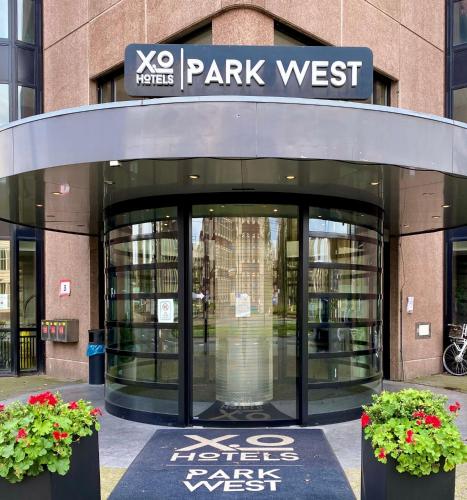 a park west entrance to a library with two plants at XO Hotels Park West in Amsterdam