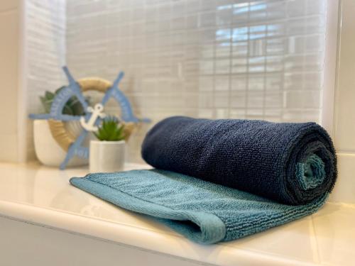a blue towel sitting on top of a bathroom counter at Sleeping Sailors Boutique Hotel in Siófok