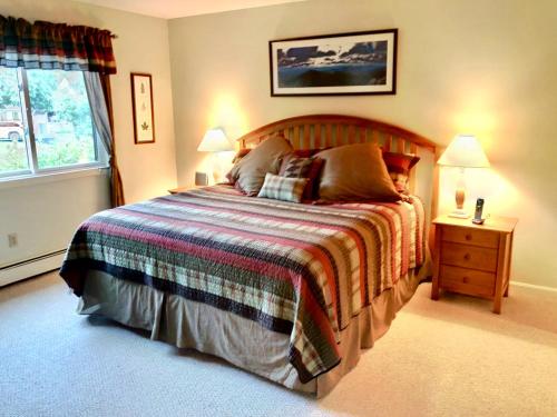 a bedroom with a large bed and a window at G4 Modern home with AC within walking distance of golf course and Mt Washington Hotel in Carroll